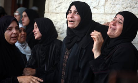 Women cry outside a hospital