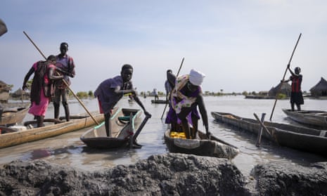 People park their canoes next to a mud dyke they built to try and prevent flooding in New Fangak, Jonglei state, South Sudan.