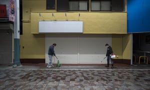 Shop owners spray disinfectant in Yokohama, Japan.