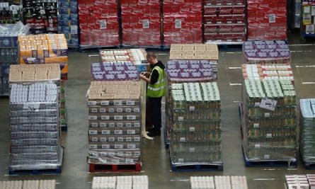 A worker in a supermarket warehouse.