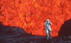 Fire of Love Film Still.
Katia Krafft wearing aluminized suit standing near lava burst at Krafla Volcano, Iceland. (Credit: Image'Est)