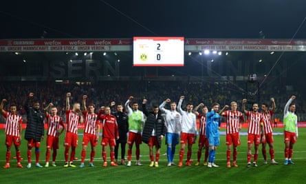 Union Berlin players celebrate in front of their fans after the 2-0 defeat of Dortmund.