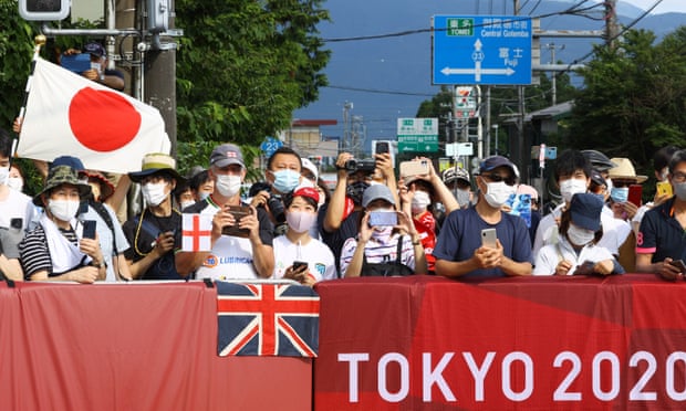 Fans line the route for the men’s road race, one of the few events open to spectators at the Tokyo Games.
