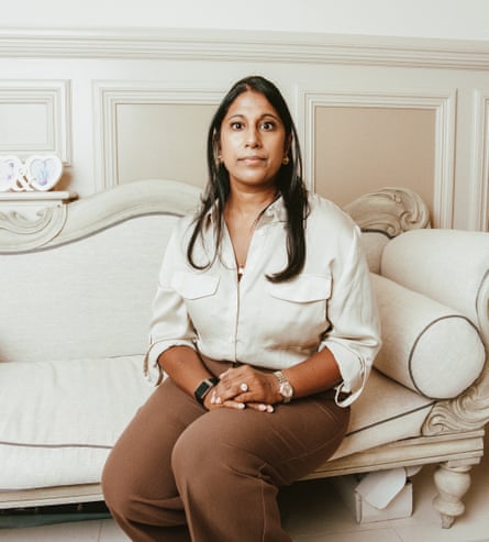 Dr Milli Raizada looking at the camera while sitting on a white sofa in a white and beige room with her hands in her lap