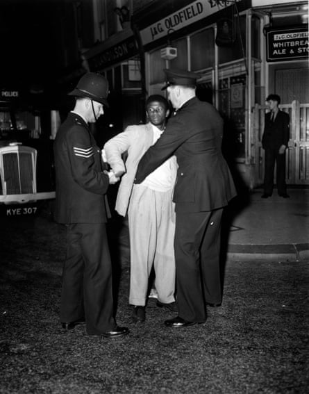 London police search a young man in Talbot Road, Notting Hill, in 1958.