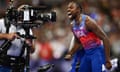 Noah Lyles screams into a TV camera after winning the men’s 100m at Paris 2024.