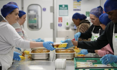 Volunteers from a charity prepare meals in a London community food hub earlier this month.