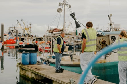 Potential recruits being shown around the fishing boats at the taster day for young people interested in career opportunities at sea in Newlyn, Cornwall.