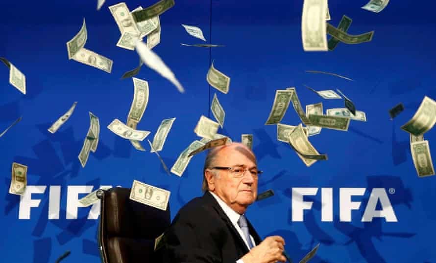 British comedian known as Lee Nelson (unseen) throws banknotes at FIFA President Sepp Blatter
