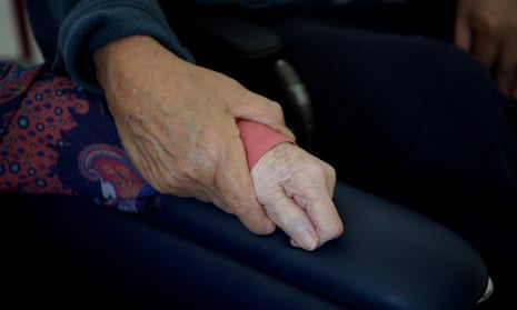 File photos of husband and wife aged care residents holding hands