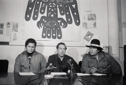 three men in front of a microphone