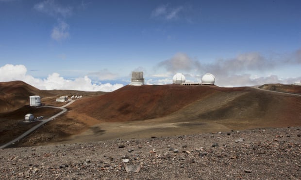 Several telescopes can be seen on the rocky mountaintop of Mauna Kea.