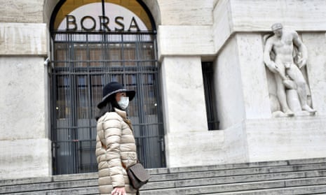 Woman in a face mask is seen in front of the Italian Stock Exchange.