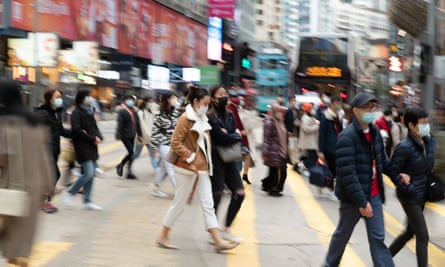 People cross the street in Causeway Bay, Hong Kong.