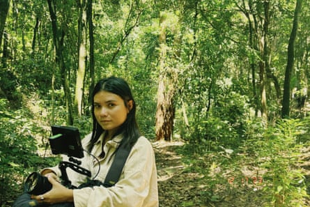 Priscila Tapajowara holds a camera in the jungle