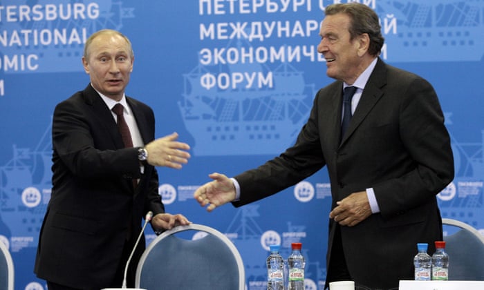 Russian President Vladimir Putin, left, and Germany’s former Chancellor Gerhard Schroeder attend an economic forum in St.Petersburg, Russia, June 21, 2012.