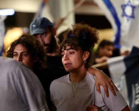 A distressed looking woman and other passengers from a Flydubai flight that made an emergency landing arrive at Ben Gurion Airport.