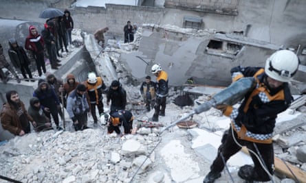 Rescuers search for survivors trapped under the rubble in the city of Sarmada, north of Idlib, in Syria.