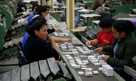 Workers sort stickers into piles at the Panini factory outside São Paolo for the 2014 World Cup collection