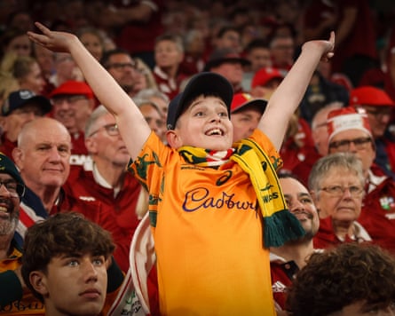 A young Australia fan finds cheer despite his side’s difficult outing in Brisbane