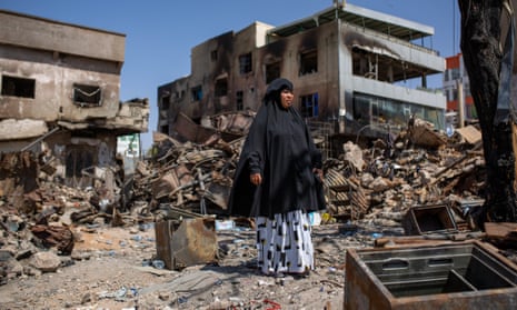 Halima Abdirahman Nur walks among the ruins of  Waheen market in Hargeisa, Somaliland