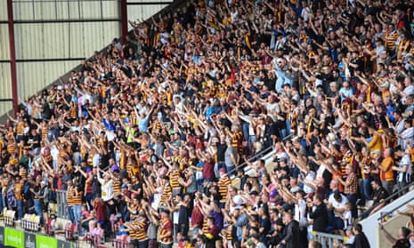 Bradford City supporters celebrate after their side score a second goal against Colchester
