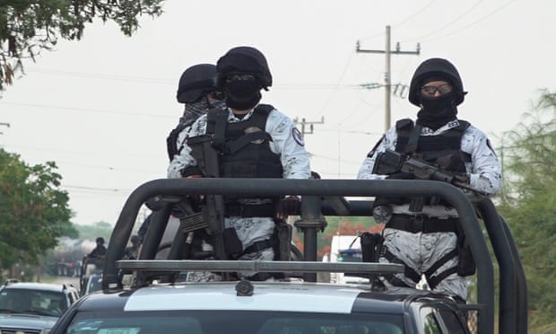 Members of Mexico’s national guard patrol a road in San Mateo del Mar, in Oaxaca state, after 15 inhabitants of an indigenous village were bludgeoned to death.