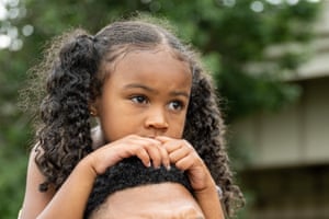 A child watches a performance from her fathers shoulders during the Juneteenth commencement of On the Banks of Freedom in Louisville, Kentucky. On the Banks of Freedom is a public art project highlighting Louisvilles unnamed slave population