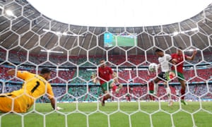 Raphael Guerreiro of Portugal (centre) scores an own goal for Germany’s second goal.