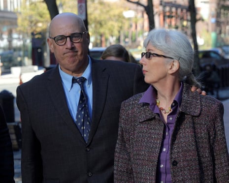 a husband and wife walk outside