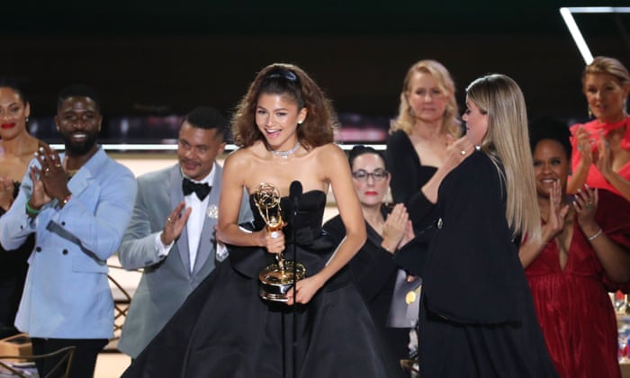 Zendaya receives her Emmy on stage on Monday night.