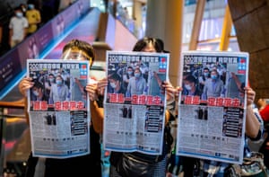 People hold up copies of the Apple Daily as they protest for press freedom inside a mall in Hong Kong on August 11, 2020.