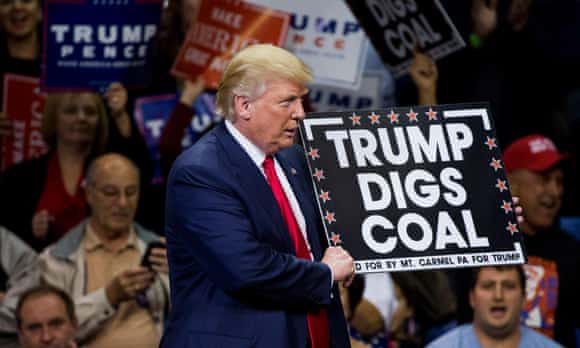 Republican presidential nominee Donald Trump holds a sign supporting coal during a rally at Mohegan Sun Arena in Wilkes-Barre, Pennsylvania.
