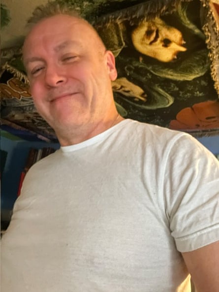 A middle-aged man smiles