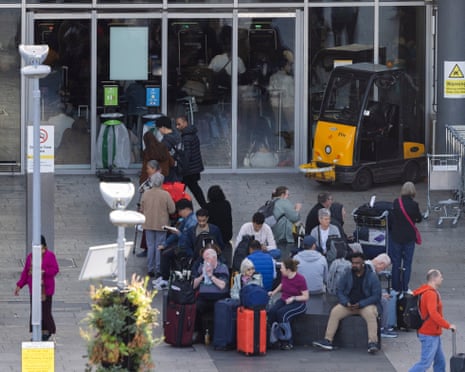 Passengers wait around outside terminal 3 at Heathrow Airport