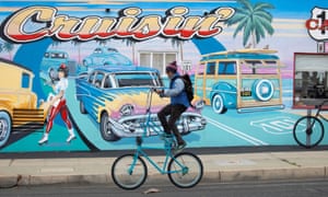 A man rides a modified bike past a diner after California lifted its regional stay-at-home orders across the state during the outbreak of coronavirus.