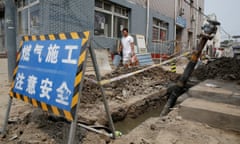 A villager walks past the gas pipeline construction instead of coal-powered boilers in Xiaozhangwan village of Tongzhou district on the outskirts of Beijing<br>A villager walks past the gas pipeline construction instead of coal-powered boilers in Xiaozhangwan village of Tongzhou district, on the outskirts of Beijing, China June 28, 2017. Picture taken June 28, 2017. REUTERS/Jason Lee - RC1B8D3BD720