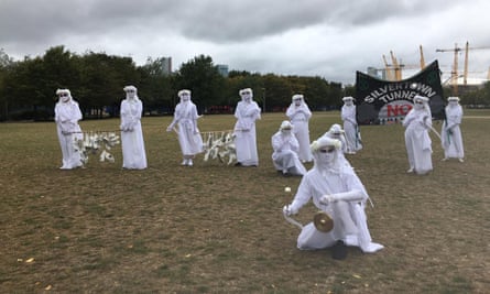 Extinction Rebellion activists don white for a secondary protest on the Greenwich peninsula.