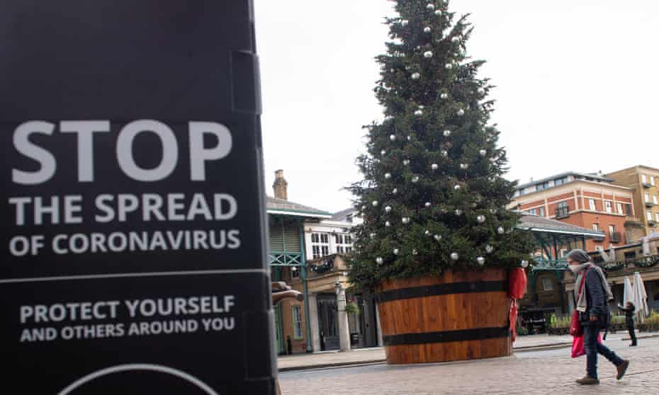 Christmas tree and coronavirus warning in Covent Garden.