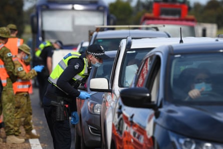 Victoria police and Australian defence force personnel at a roadside checkpoint near Donnybrook on Wednesday as police enforced a ‘ring of steel’.