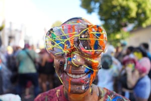 A reveller wearing paint-streaked goggles smiles