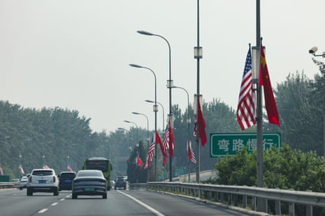 US and Chinese flags line a street near the airport.
