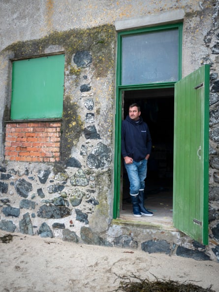 Fisherman Matthew Pascoe standing in an open doorway in St Ives, Cornwall, UK