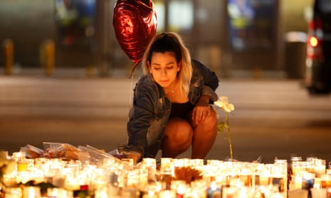 A woman lights candles at a vigil on the Las Vegas Strip. Fundraisers, food donations, and blood drives are taking place across the city. 