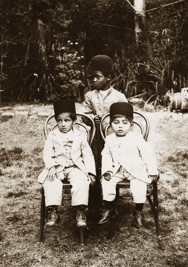 Qubad Il-khan Bakhtiari (right) and Hossein Il-khan Bakhtiari (left), sons of paramount Bakhtiar chief Il-khan Khosrow Zafar Bakhtiari, seated in a garden, probably in Isfahan, with their African slave, 1904. According to Khosronejad, this photo shows that slave ownership in Persia extended beyond the Qajar monarchy to tribal chiefs.