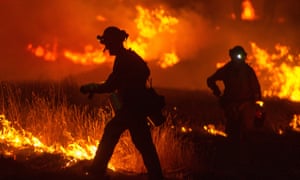 A firefighter lights a backfire as the Rocky fire burns near Clear Lake, California, on Monday night