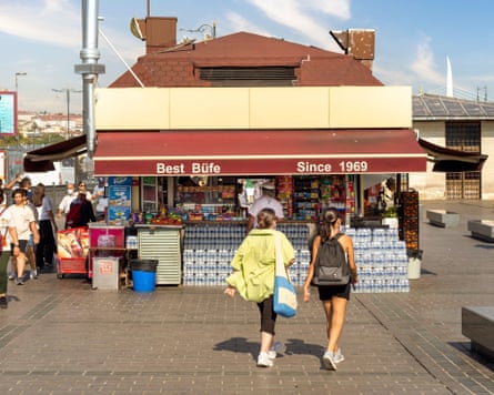A kiosk offering snacks and drinks in a busy paved area