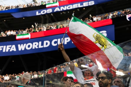 An Iran fan shows pre-revolution Lion and Sun flag during the game against New Zealand at Los Angeles Stadium