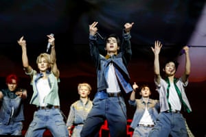 Boy band members perform a synchronised routine