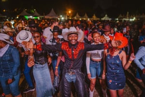 A large crowd dance after darkness falls